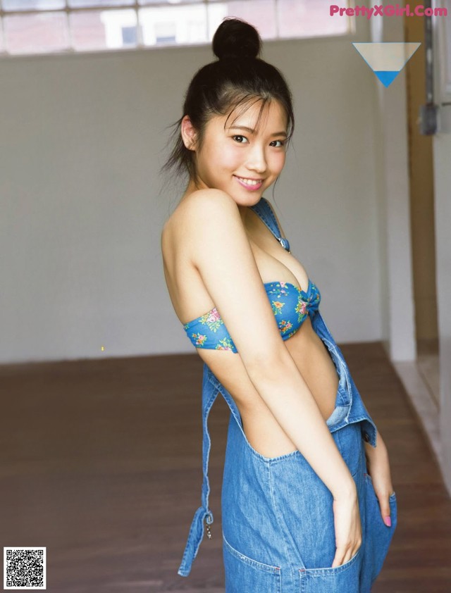 A woman in a blue dress is posing for a magazine cover.