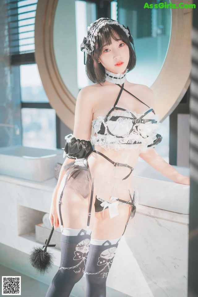 A woman in lingerie posing in front of a mirror.