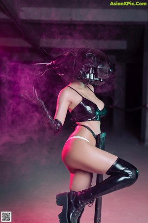 A woman in a black and white outfit holding a pink smoke bomb.