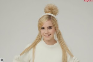 A woman sitting on top of a white couch.