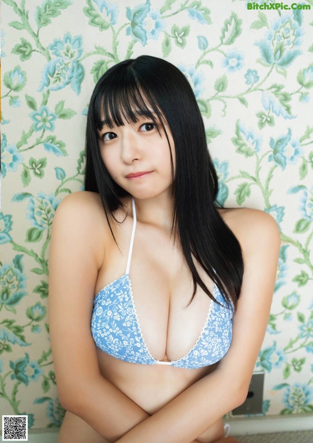 A woman in a blue and white bikini posing for the camera.