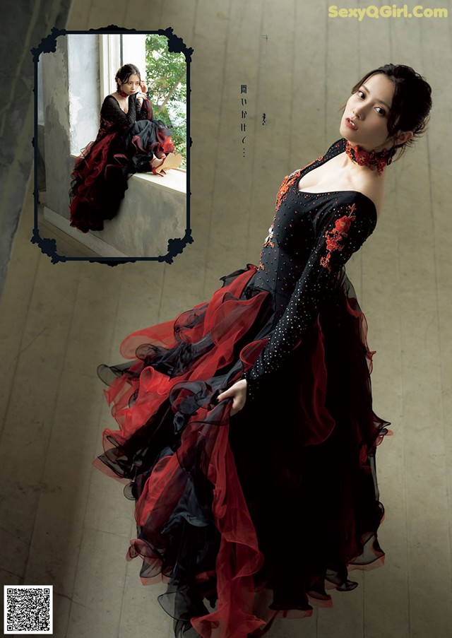 A woman in a black and red dress posing for a picture.