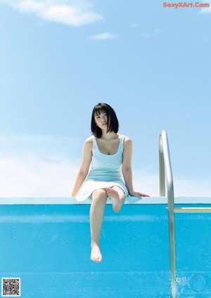 A woman in a school uniform standing on the side of a road.