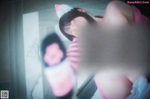 A woman in a pink outfit is sitting on a bed.