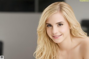 A young woman in a white top and blue jeans posing for a picture.