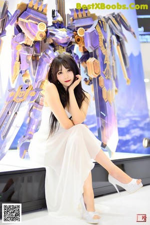 A woman dressed in a costume holding a sword.